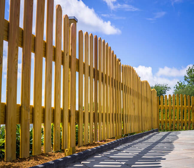 Picture of a wooden fence surrounding a concrete path